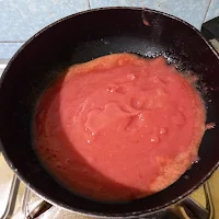 Tomato Puree poured into non stick pan for cooking