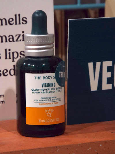 The Body Shop Vitamin C Glow Revealing Serum, in large, dark glass bottle and pipette top.