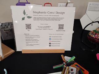 Sign with maker's name and contact information, and QR code