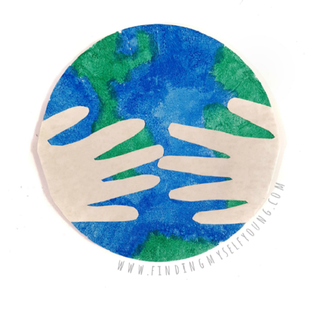 earth day paper plate with hands stuck on front