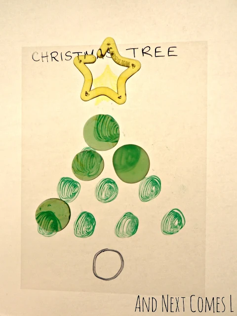 Christmas tree shape made with green glass stones and a star shape on the light table