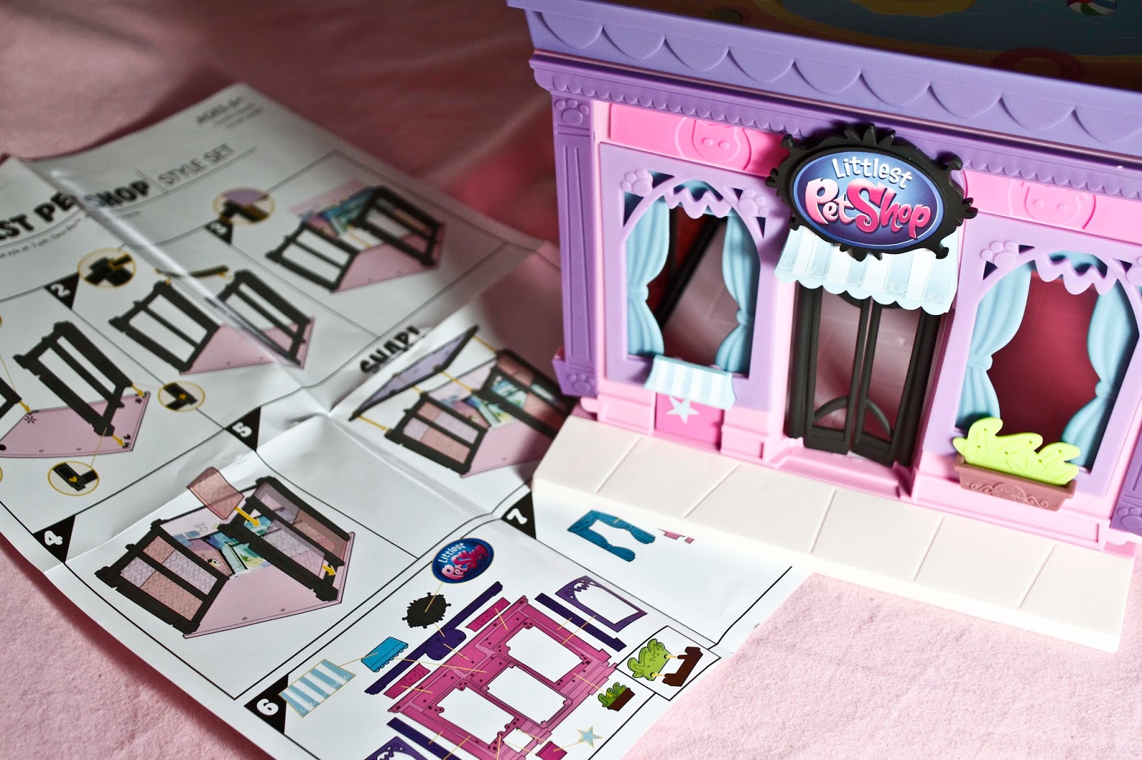 simple to follow instructions with the completed littlest pet shop building next to the littlest pet shop style set