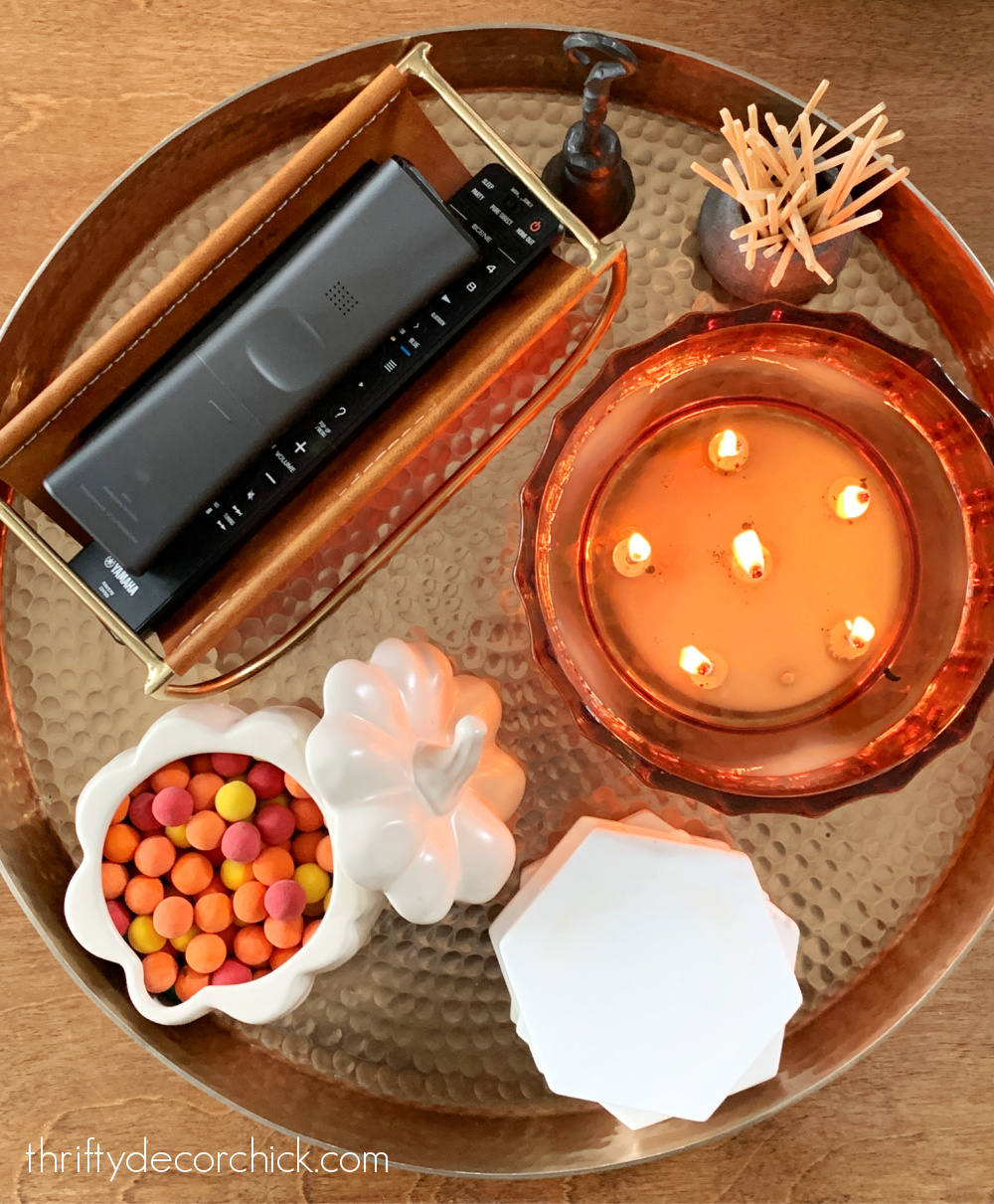 candle and remotes on tray