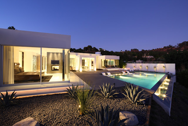 Modern home and its swimming pool at night 