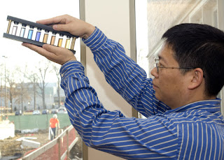 Younan Xia holds an array of glass vials