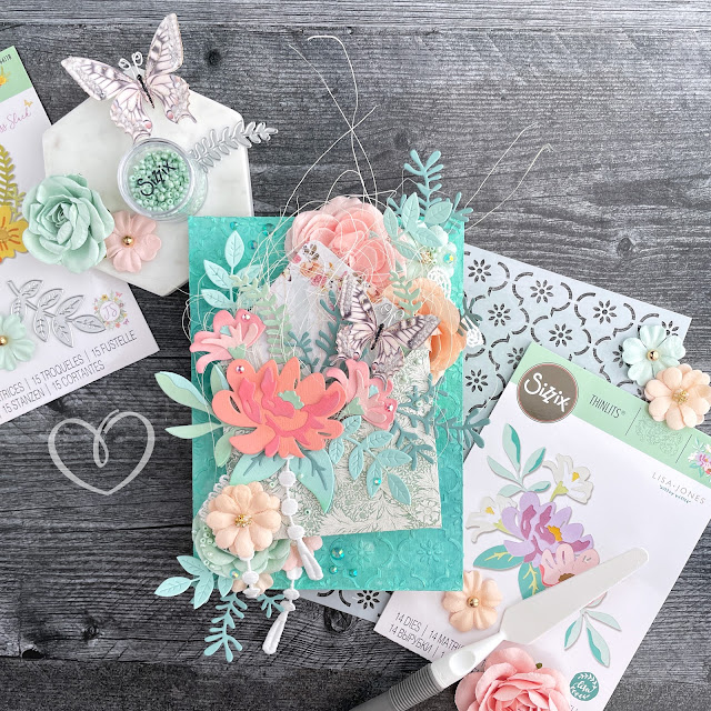 Mixed media panel with a Distress Spray and stenciled paste background, an envelope with die cut flowers and leaves, a Reneabouquets butterfly, and Prima Marketing flowers.