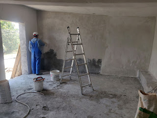 Bekir reaches the end of the wall plastering