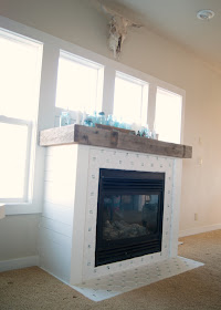 Fireplace Makeover - DIY Fireplace makeover using reclaimed and salvaged materials - octagon & dot tile, reclaimed wood,  white paint, planking - all for under $60! Before and After and links to all the steps!