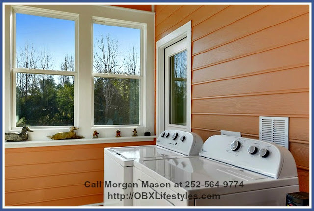 The laundry room of this 4 bedroom equestrian property for sale on the Outer Banks NC features a new high-efficiency top loading Whirlpool washer and dryer. 