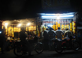 people buying flower garlands