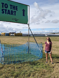 Me standing next to a sign that says to the start.