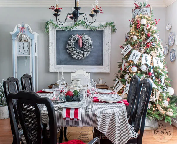 dining room with large chalkboard and tree decorate with an O Holy Night banner