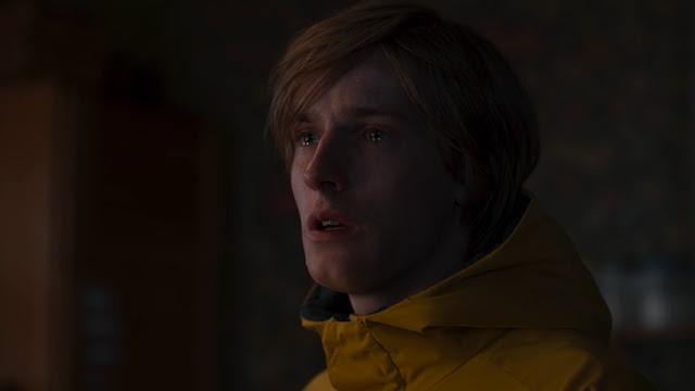 a boy in a yellow raincoat has tears in his eyes