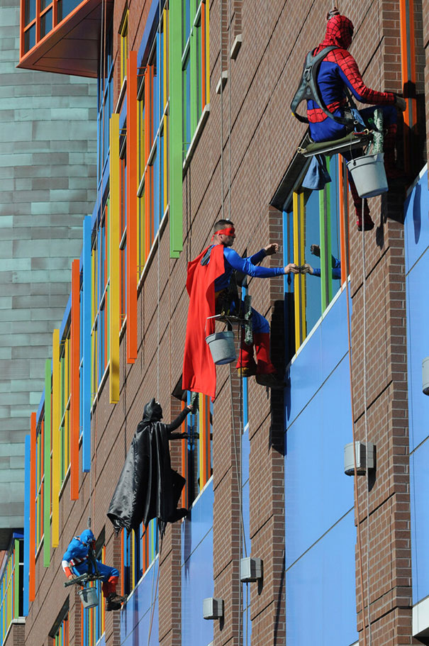 Workers from memphis cleaning company dress up as superheroes to cheer up patients at children's hospital in le bonheur.