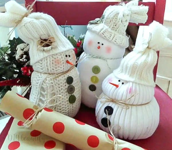 a trio of snowmen crafted from sweaters