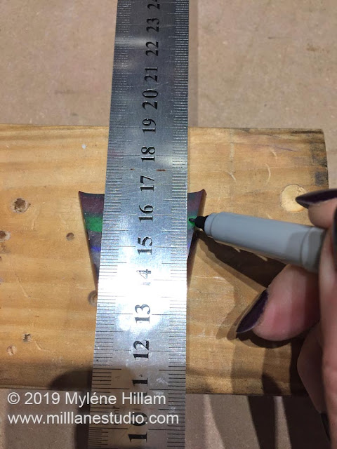 Using a ruler to mark the cutting lines to shape the ring