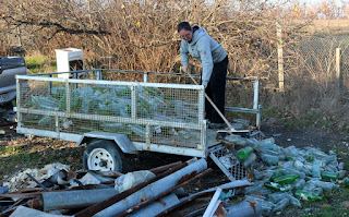 A sweeping the old bottles out of the trailer