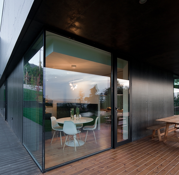 Glass corner wall in Black Concrete House by Pitagoras Arquitectos