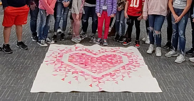 An Exploding Heart quilt sewn as a group project with kids during a homeschool co-op class