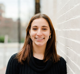 photo of a young woman smiling at the camera.