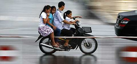 A Cambodian family rides