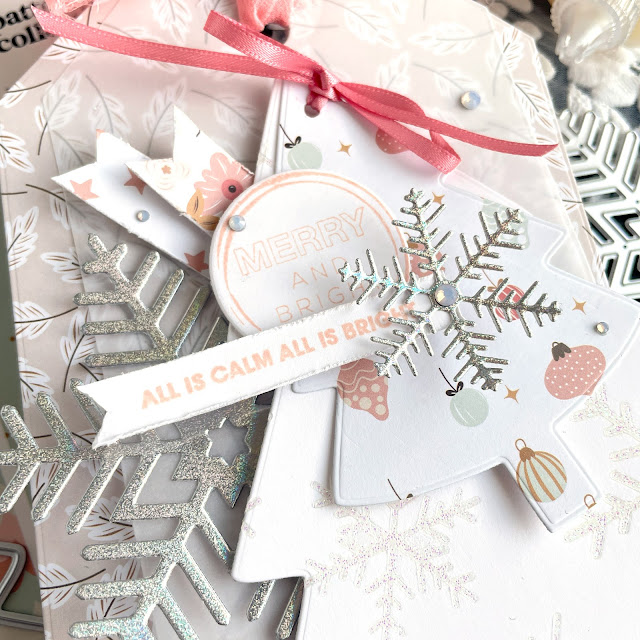 Winter Christmas tag with Scrapbook.com Snow Days and Holographic paper, vellum, snowflake die, nested tag die, nested tree die, snowflake pops of color and mixed media paper.