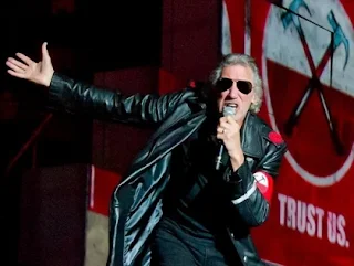 Roger Waters wearing a Nazi-style uniform and holding a gun on stage at his Berlin concert