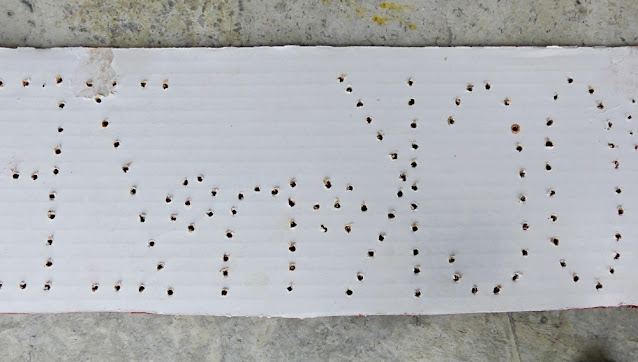 Cardboard screw template & holder for spray painting screws.