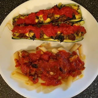 Stuffed Zucchini Boats on Plate with Pasta and Sauce