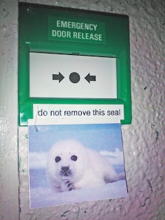 Emergency Door Release do not remove this seal, emergency door funny picture, seal, funny picture seal