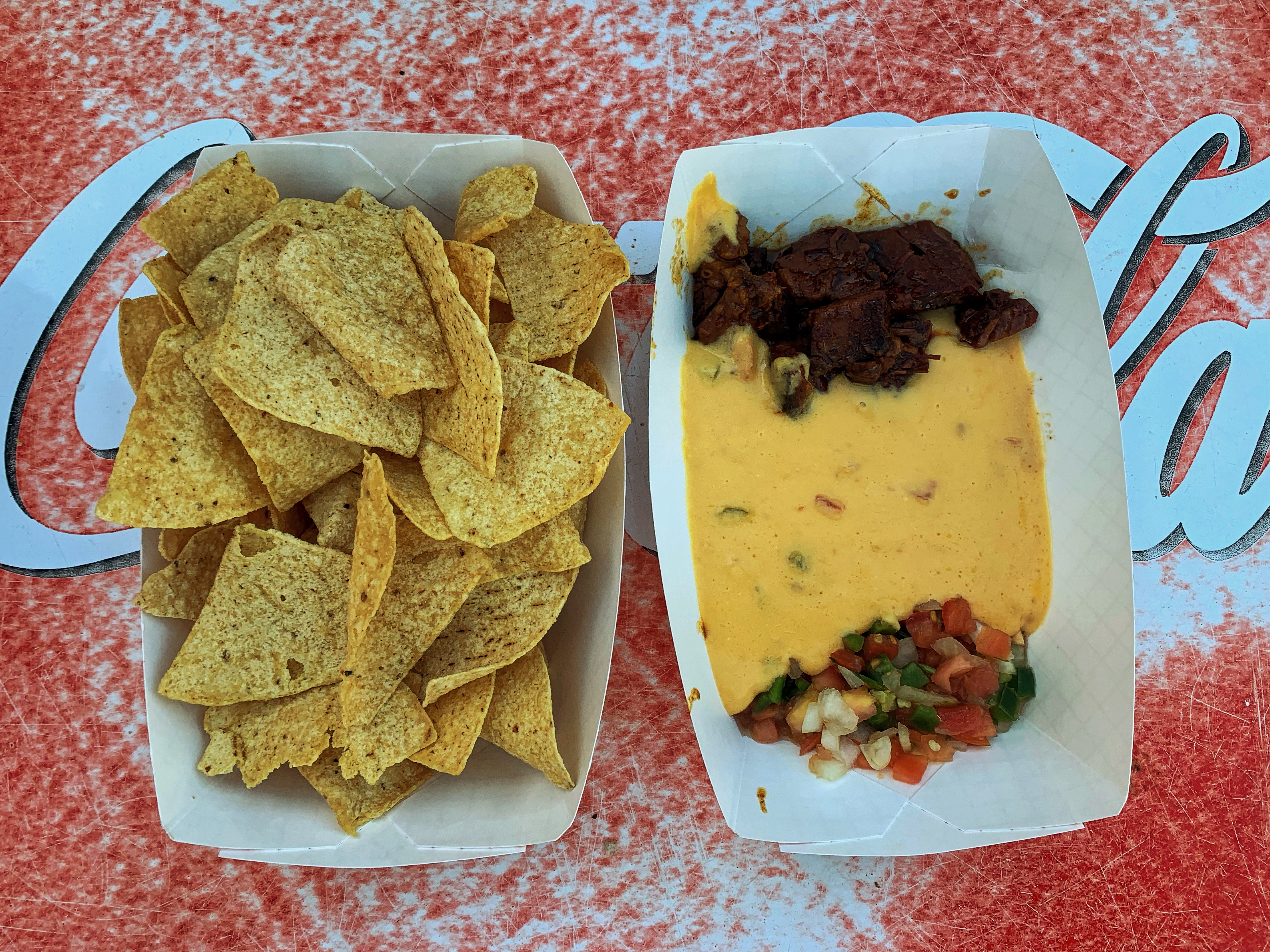 nachos with queso, pico de gallo, and beef brisket