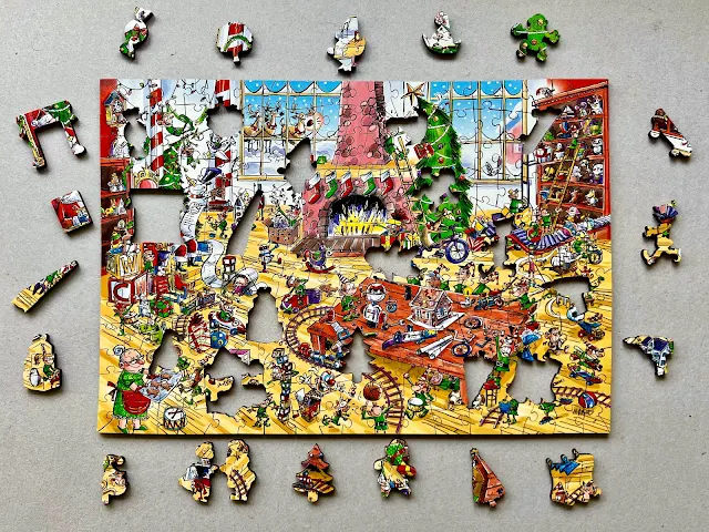 The completed Wentworth Puzzles jigsaw of Santa's Workshop with all the special shaped pieces removed and placed around the edge