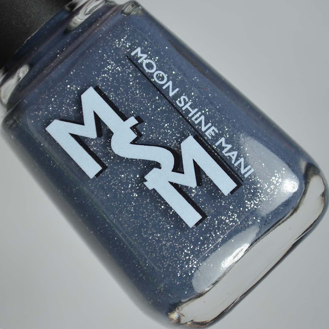 denim blue nail polish with silver glitter in a bottle