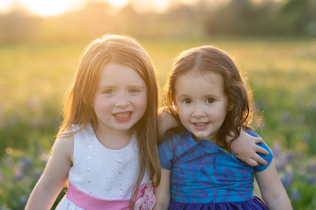 girls in bluebonnet flower field