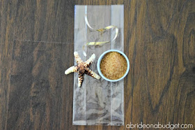 If you need a favor idea for your beach wedding, check out the DIY Chocolate Seashell And Sand Favors from www.abrideonabudget.com.