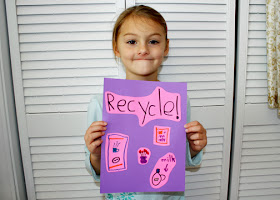 You wouldn't know it from her "smile," but Tessa had a blast designing her own conversation poster. She chose to remind people to recycle cans, paper, plastic and glass.