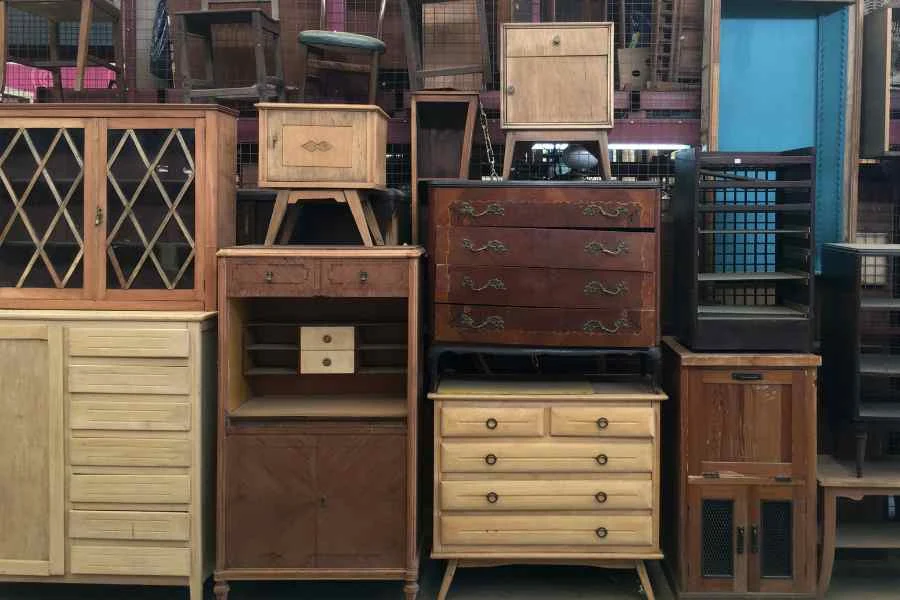 Vintage furniture stacked up in a flea market from Canva Pro by FotografiaBasica from Getty Images Signature