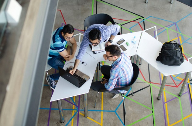 Three co-business owners are seen here using technology to personalize sales