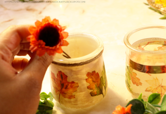 floral being placed into a glass jar