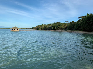 Calm ocean with hut on it on a nice sunny day