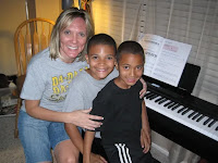 Mom and her 2 sons playing piano