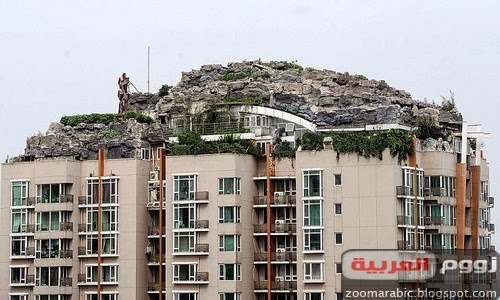 صيني يبني هضبة صخرية وفوقها فيلا