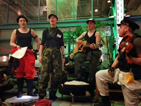 Fyra musiker, två män, två kvinnor, utklädda till Grävare sjunger på scen.