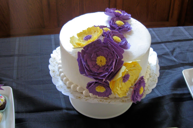 This is a cake decorated with paper peony flowers.