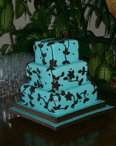 Four tier square chocolate wedding cake with powder blue trimming