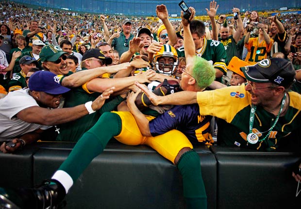 Donald Driver jumps into the crowd after catching a six-yard touchdown pass