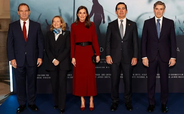 Queen Letizia wore a burgundy, maroon, wine red, high neck open-back dress by Massimo Dutti. Black coat