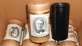 A photograph of a pile of wax cylinders.