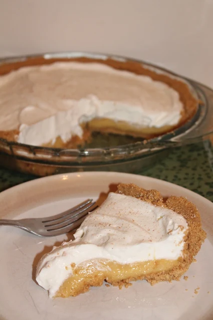 Eggnog pudding pie slice on a serving plate.