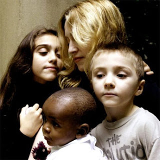 Madonna with kids and adopted african